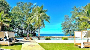 A resort with a pool area, lounge chairs, and palm trees. - Estella Phuket Mai Khao Beach Resort (Mai Khao)