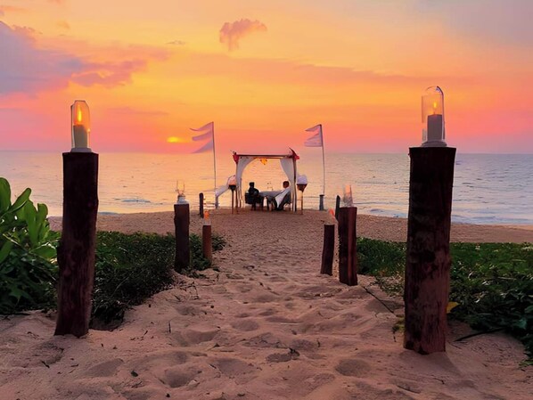 A beach pathway leading to a gazebo with flags, surrounded by wooden posts and plants. - Estella Phuket Mai Khao Beach Resort (Mai Khao)