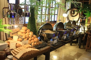 A buffet setup with various food items, including bread, pastries, and hot dishes, arranged on a table with a sign indicating 'Casty Treats'. - Swagman Hotel (Manila)
