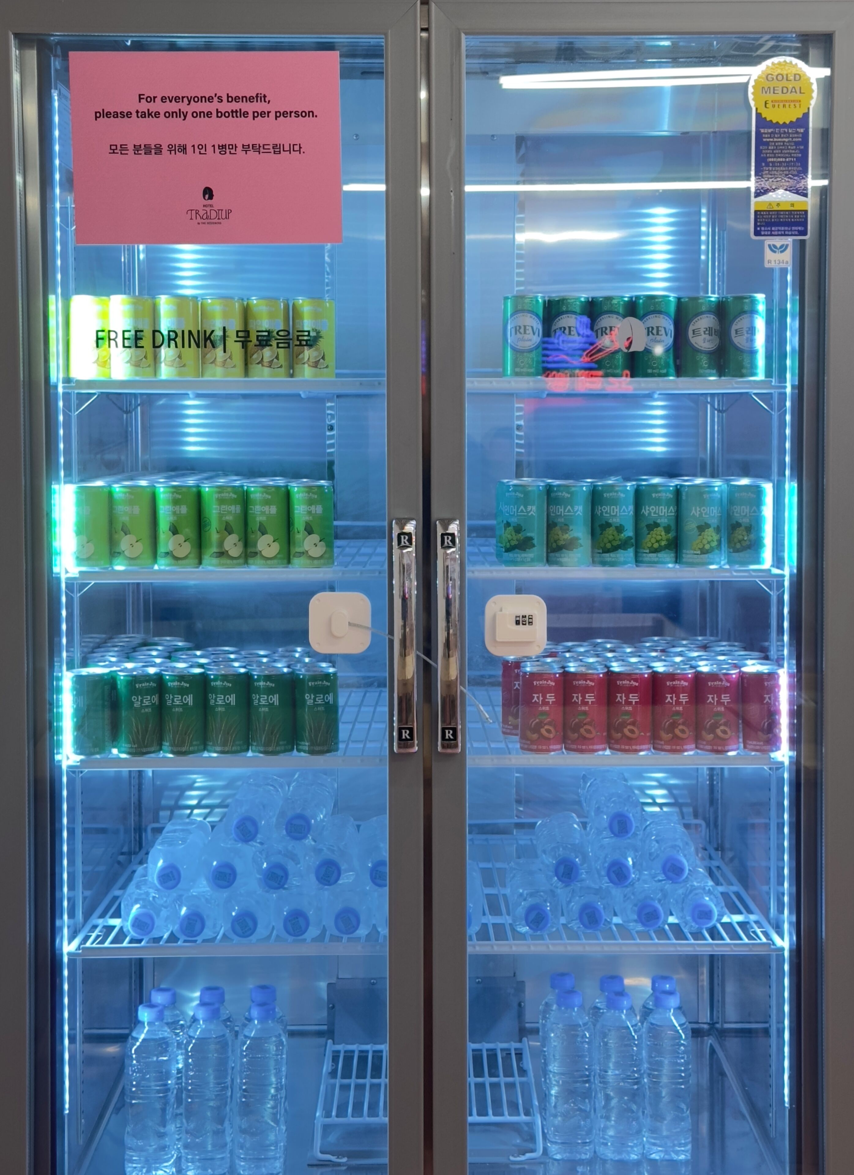 A beverage vending machine with multiple drink options, including water and various sodas.