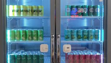 A beverage vending machine with multiple drink options, including water and various sodas.