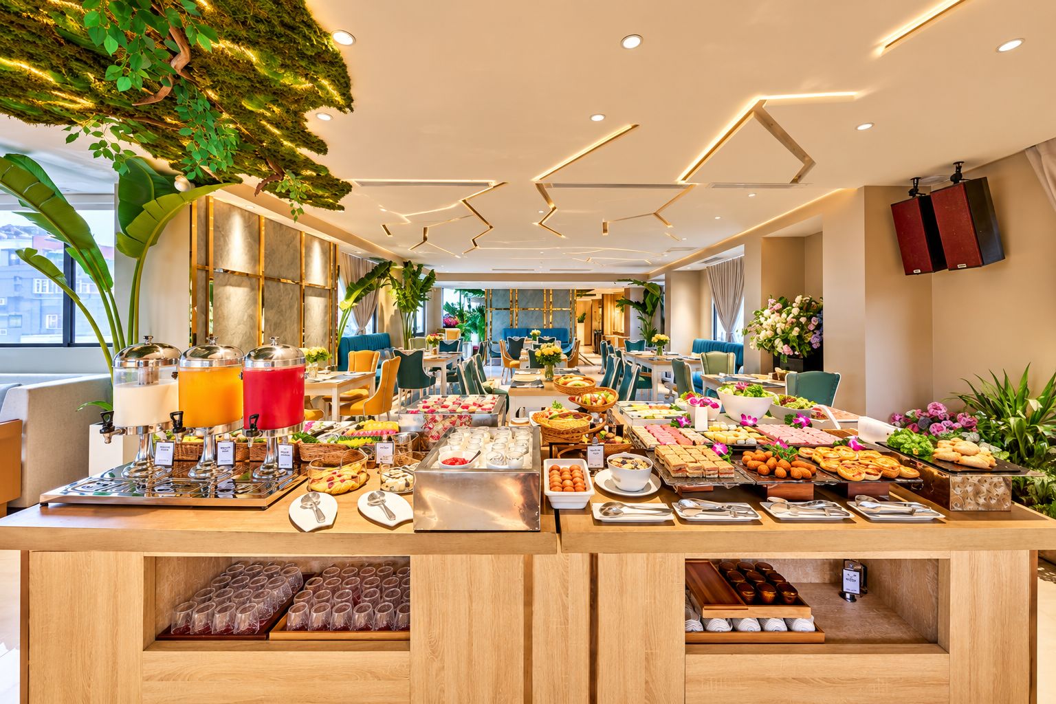 A buffet setup with various food items and a modern interior design.