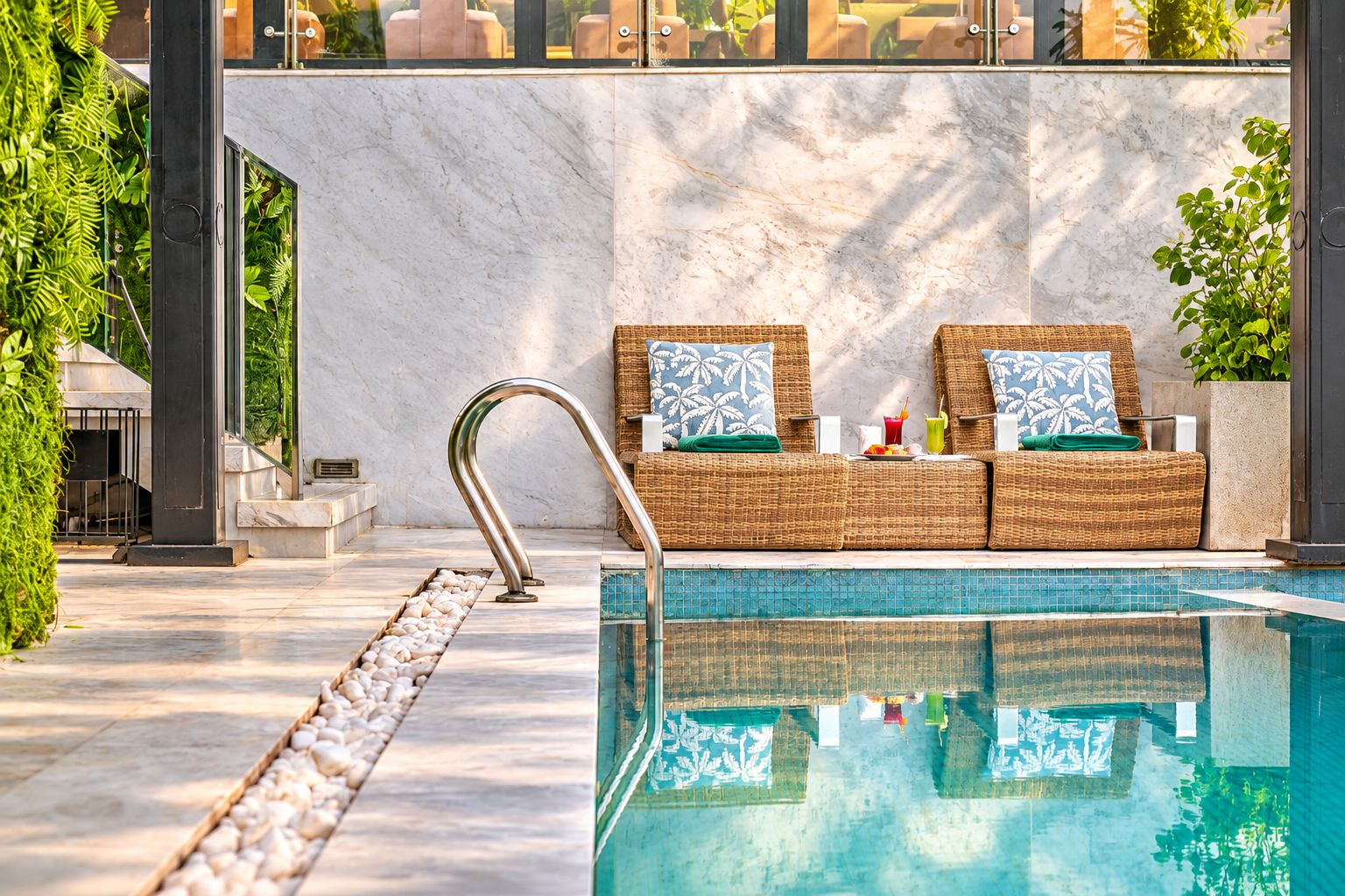 A poolside area with a lounge chair and a metal pool ladder.
