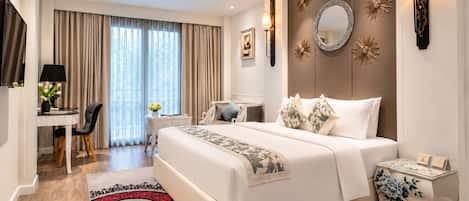 A hotel room with a bed, bedside tables, a desk with a chair, a TV, and a large window with curtains.