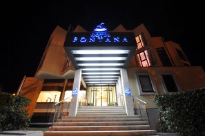 A hotel entrance with a sign reading "Hotel Fontana" and a staircase leading up to the doors. - Hotel Fontana (Buzet)