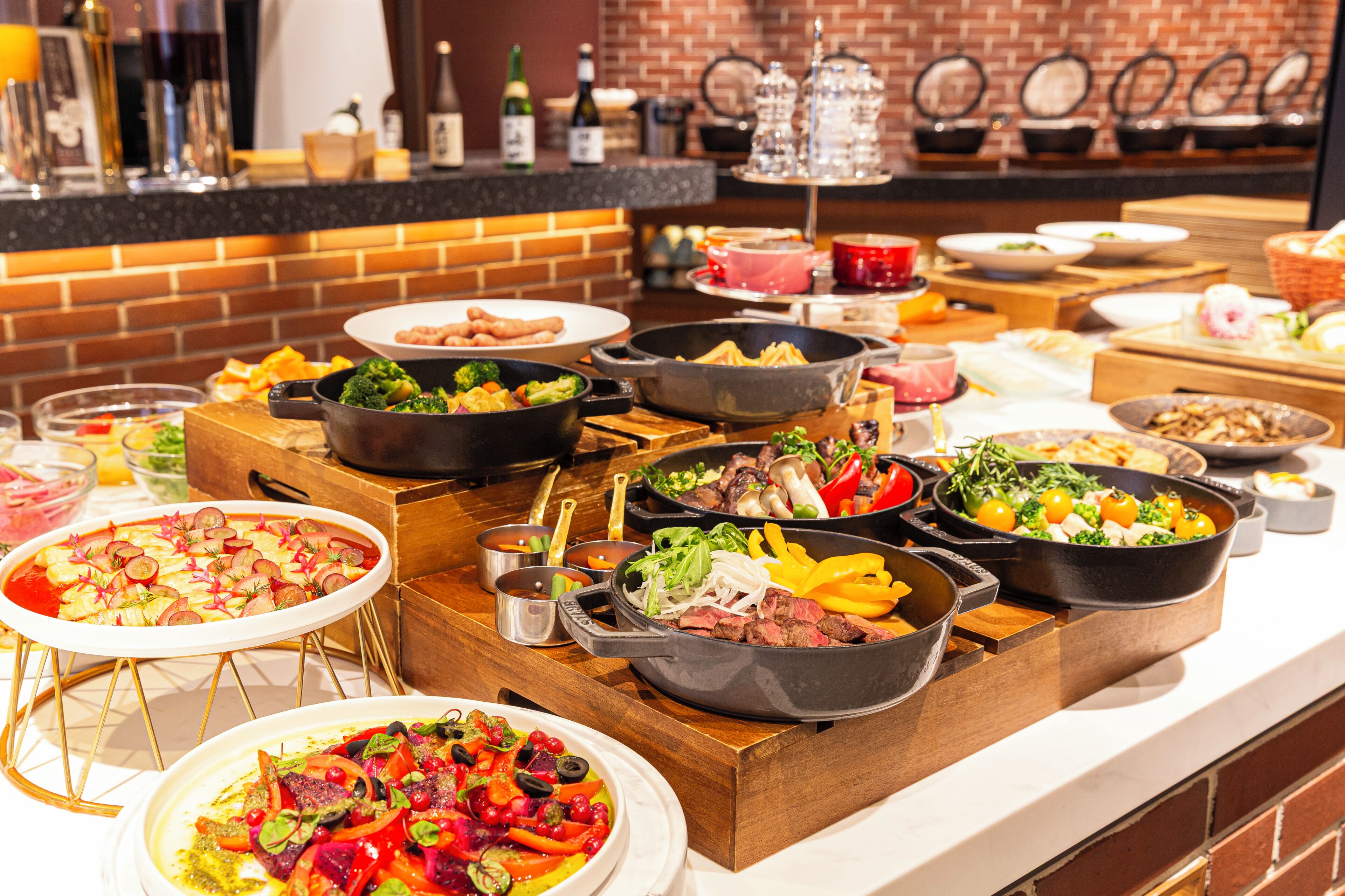 A buffet with various dishes, including salads, meats, and vegetables.