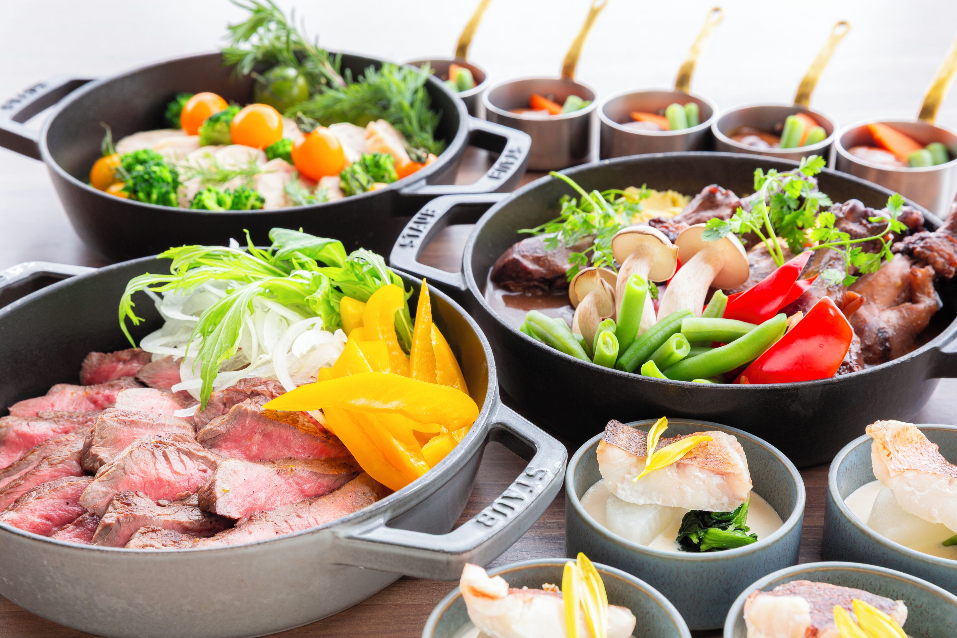 A variety of dishes in pots and bowls, including meat, vegetables, and seafood.