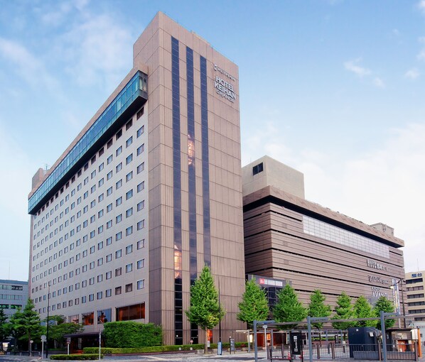 A modern hotel with multiple floors, large windows, and a prominent sign. - Hotel Keihan Kyoto GRANDE (Kyoto)