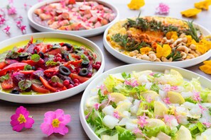 Four plates of colorful salads with various vegetables and garnishes. - Hotel Keihan Kyoto GRANDE (Kyoto)