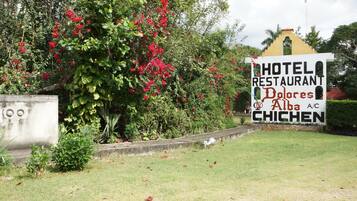 A sign for Hotel Restaurante Dolores Alba A/C Chichen.