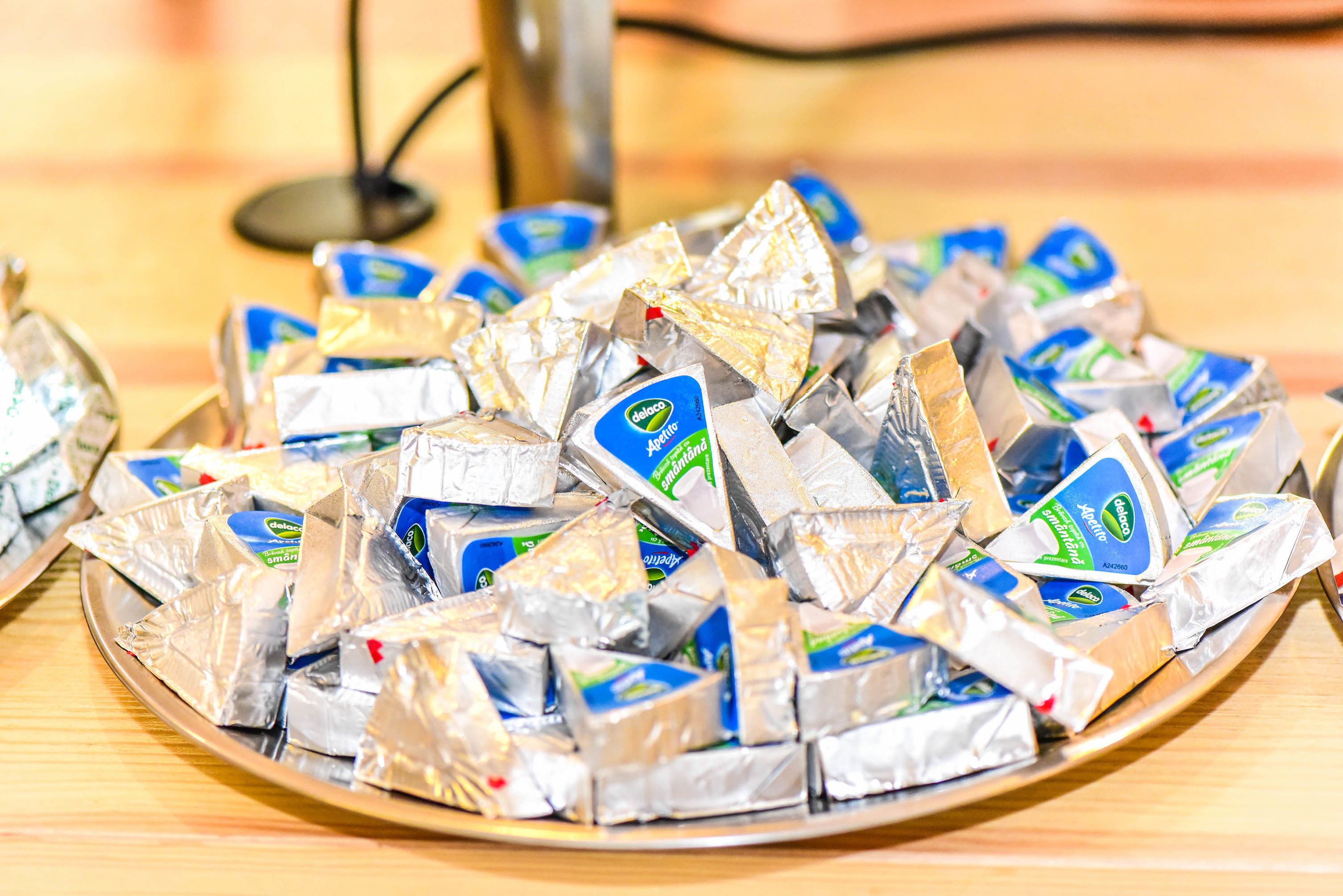 A tray of packaged food items on a wooden table.