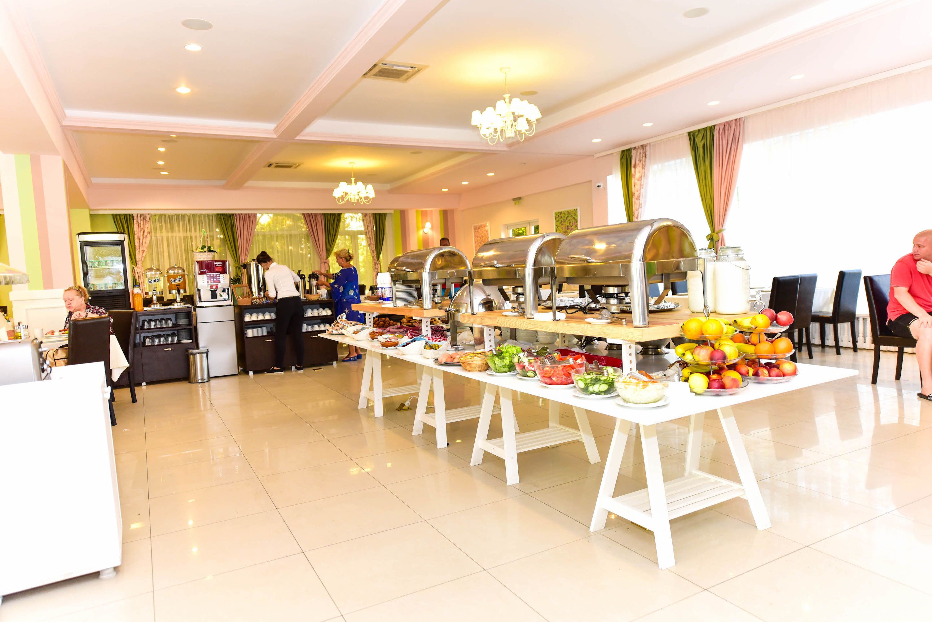 A buffet setup with various food items and a beverage station.