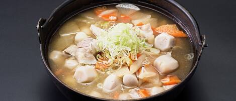 A bowl of soup with various ingredients.