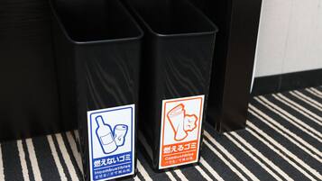 Two trash bins with labels indicating they are for non-combustibles and combustibles.