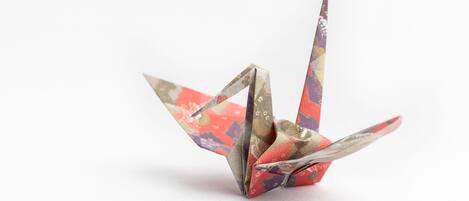 A paper crane with a patterned design.