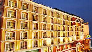 A multi-story hotel with balconies, large windows, and a sign indicating it is an intimate hotel. - Intimate Hotel Pattaya (Pattaya)