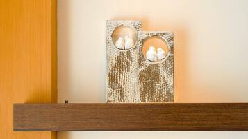 A wooden shelf with two decorative panels featuring circular cutouts.