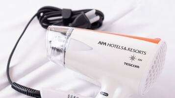 A white hair dryer with a black cord and a clear protective cover.