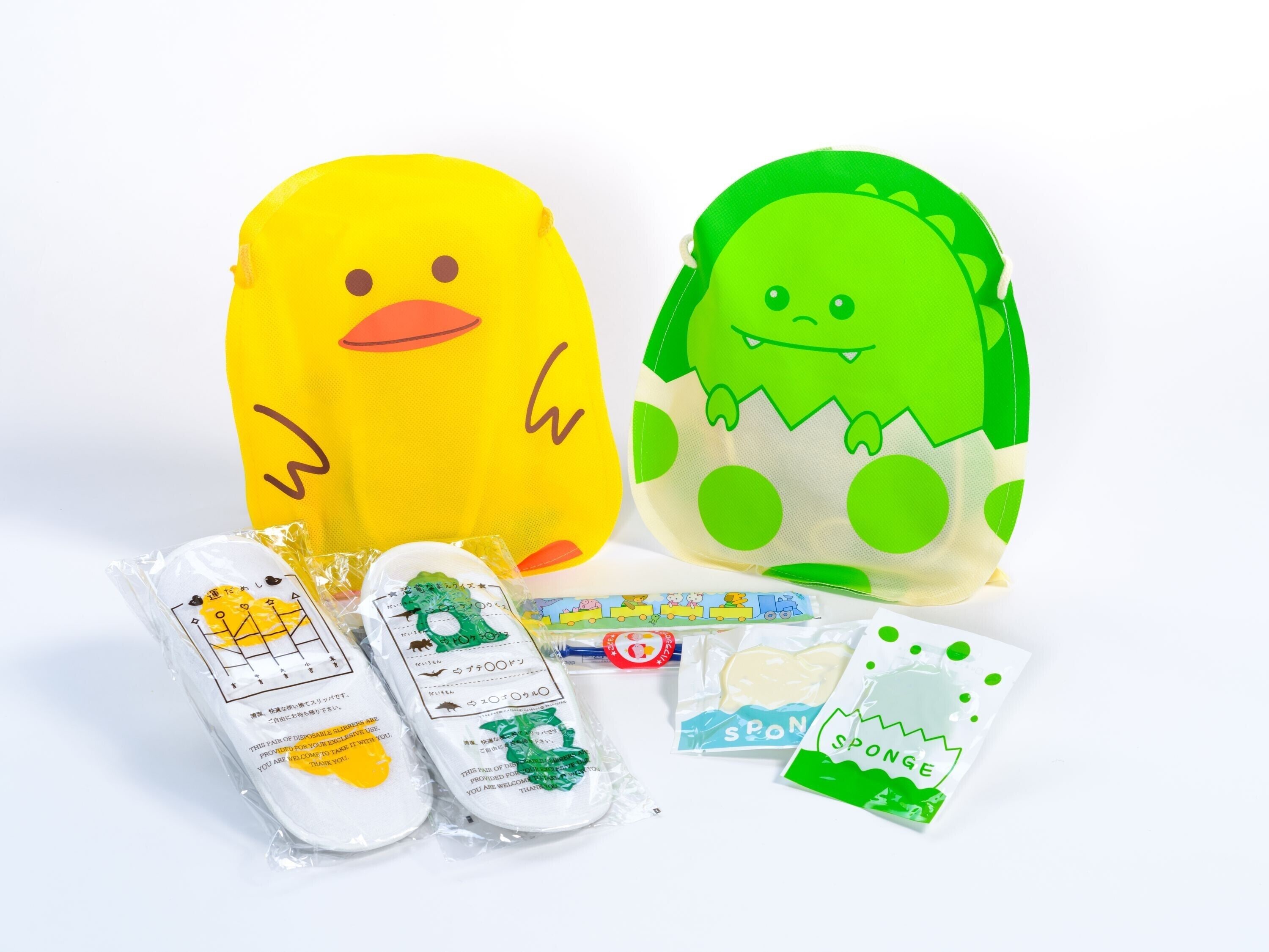 Two plush toys, a yellow duck and a green monster, along with some packaged items.
