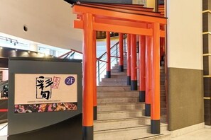 A staircase with orange railings leading to an upper floor. - APA Hotel Kanazawa Ekimae (Kanazawa)