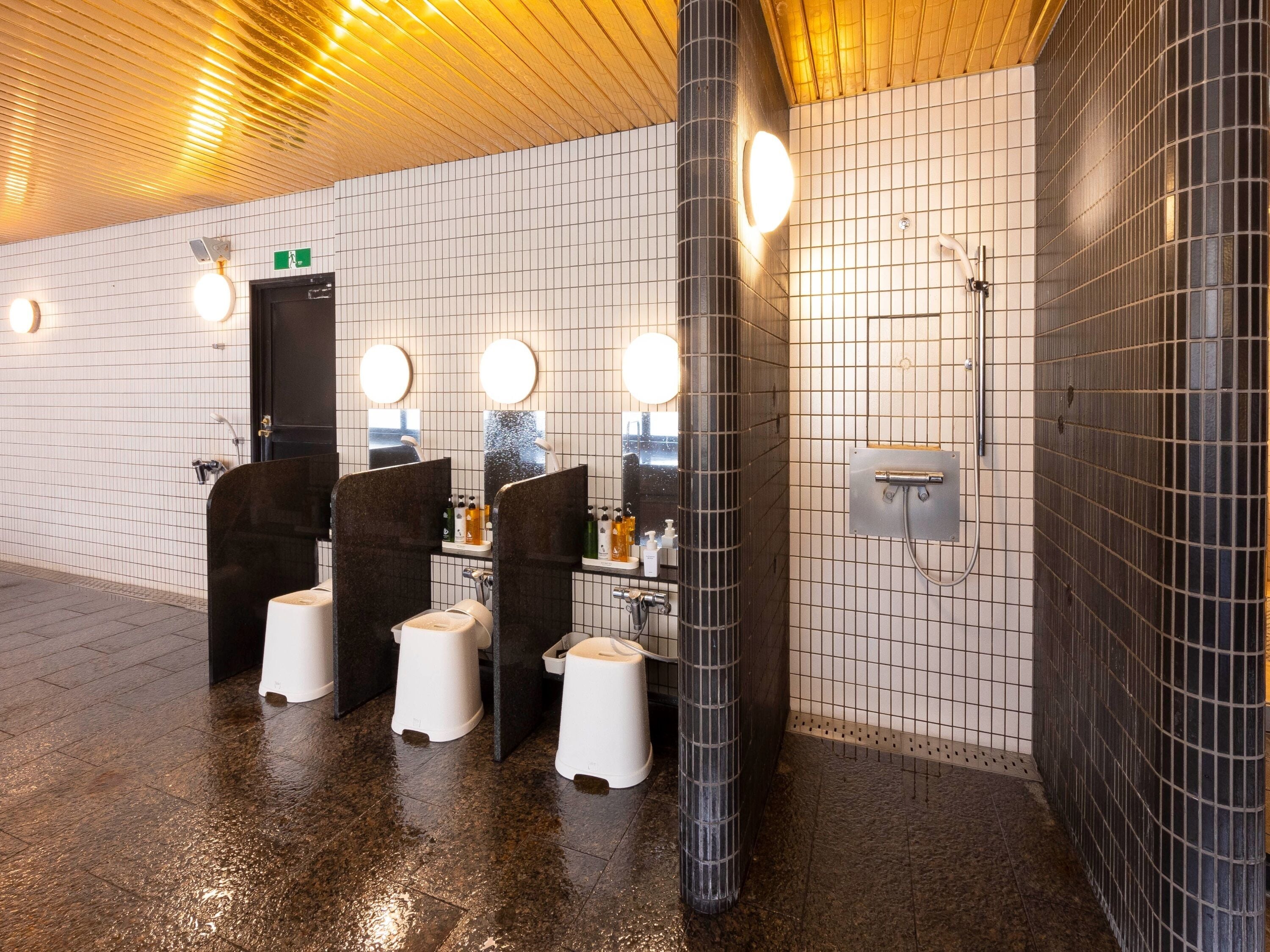 A public restroom with multiple urinals, sinks, and mirrors.
