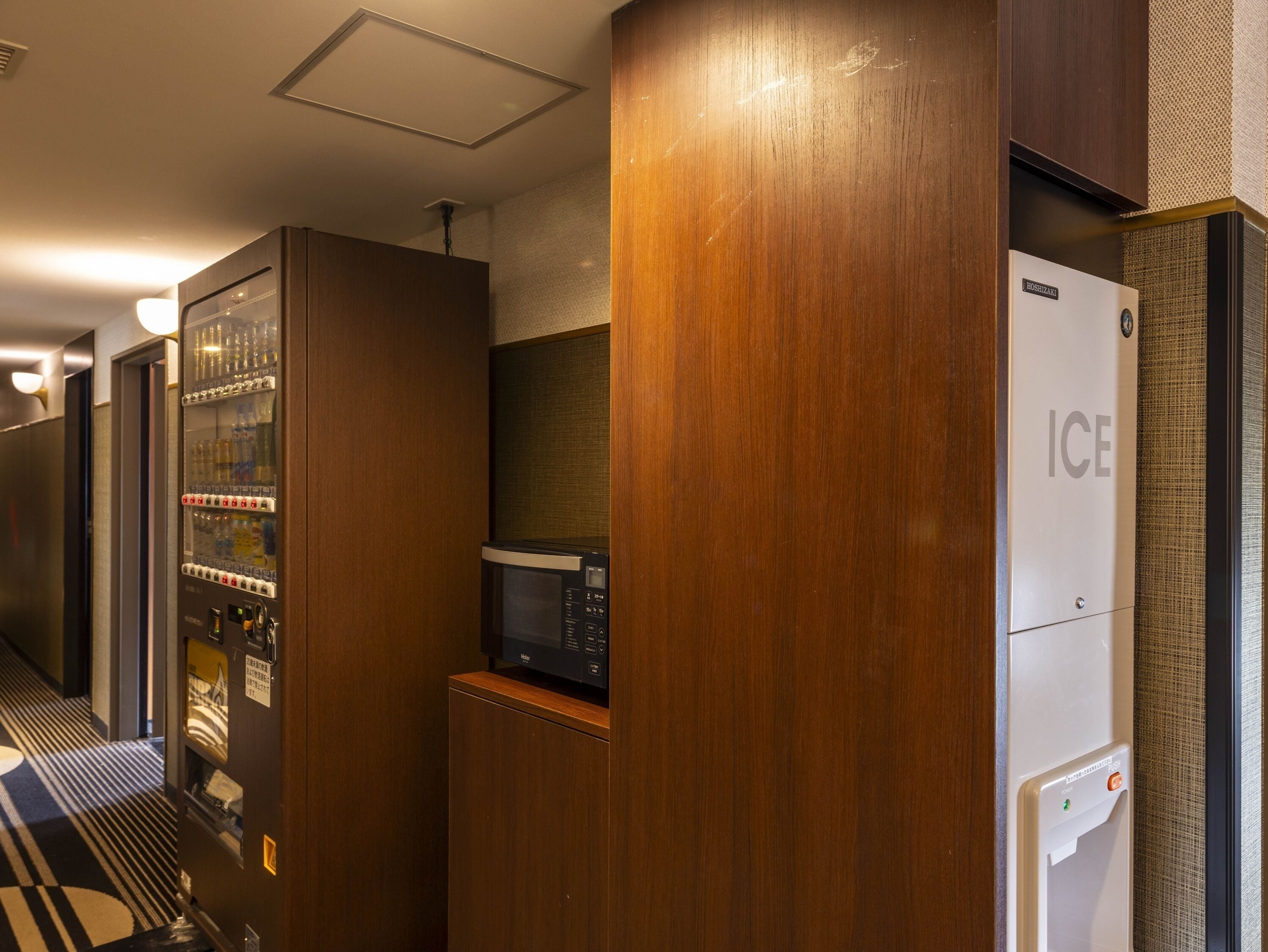 A hotel corridor with a vending machine, a microwave, and an ice dispenser.
