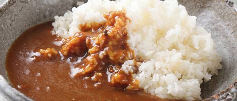 A bowl of white rice with a brown sauce.