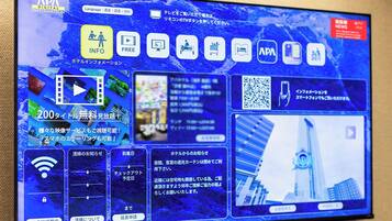 A digital display with various icons and information, including a QR code, Wi-Fi signal, and a video play button.