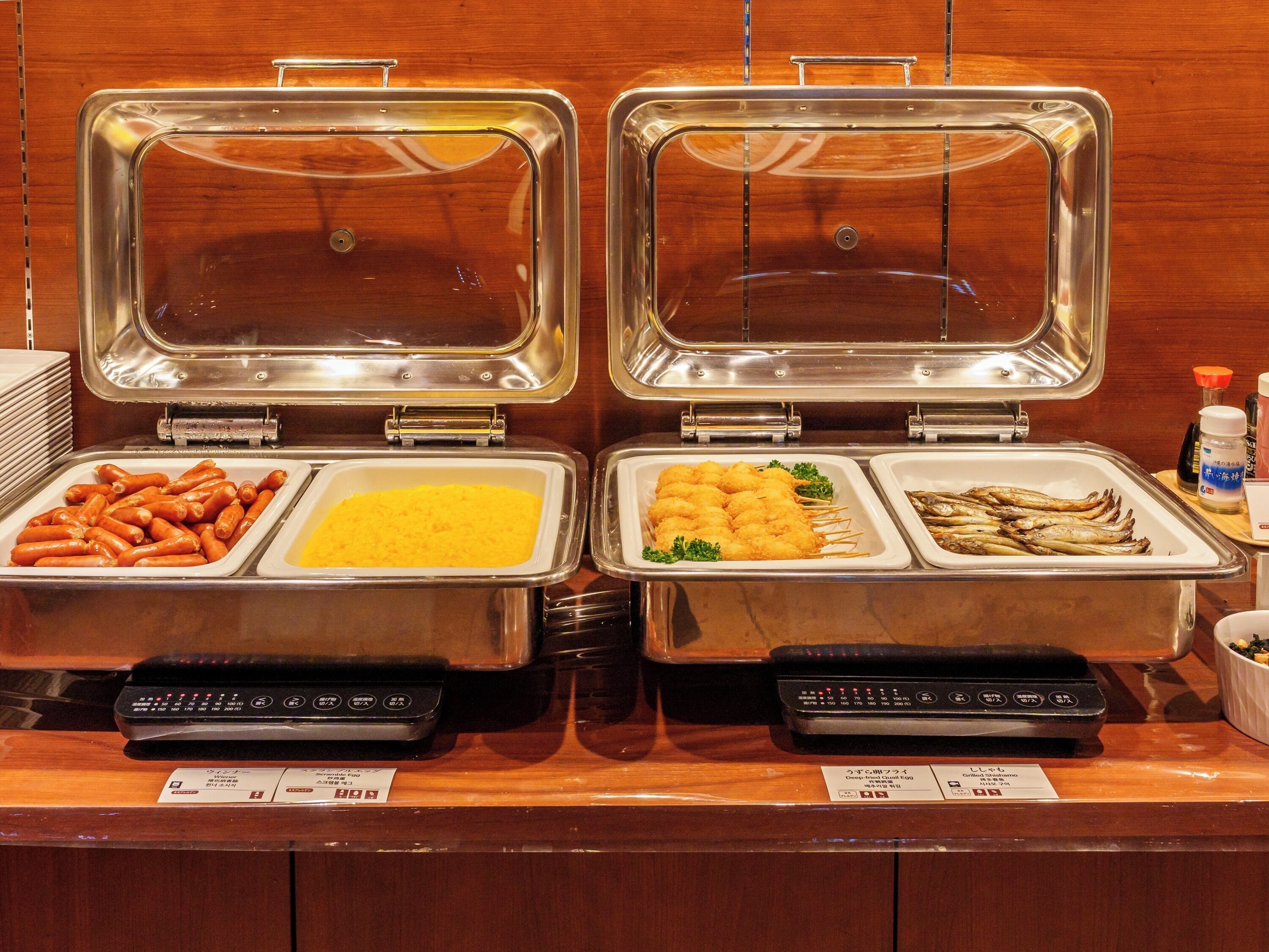 A buffet with various food items in separate containers.