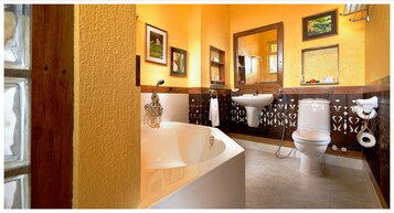A bathroom with a bathtub, toilet, and sink.