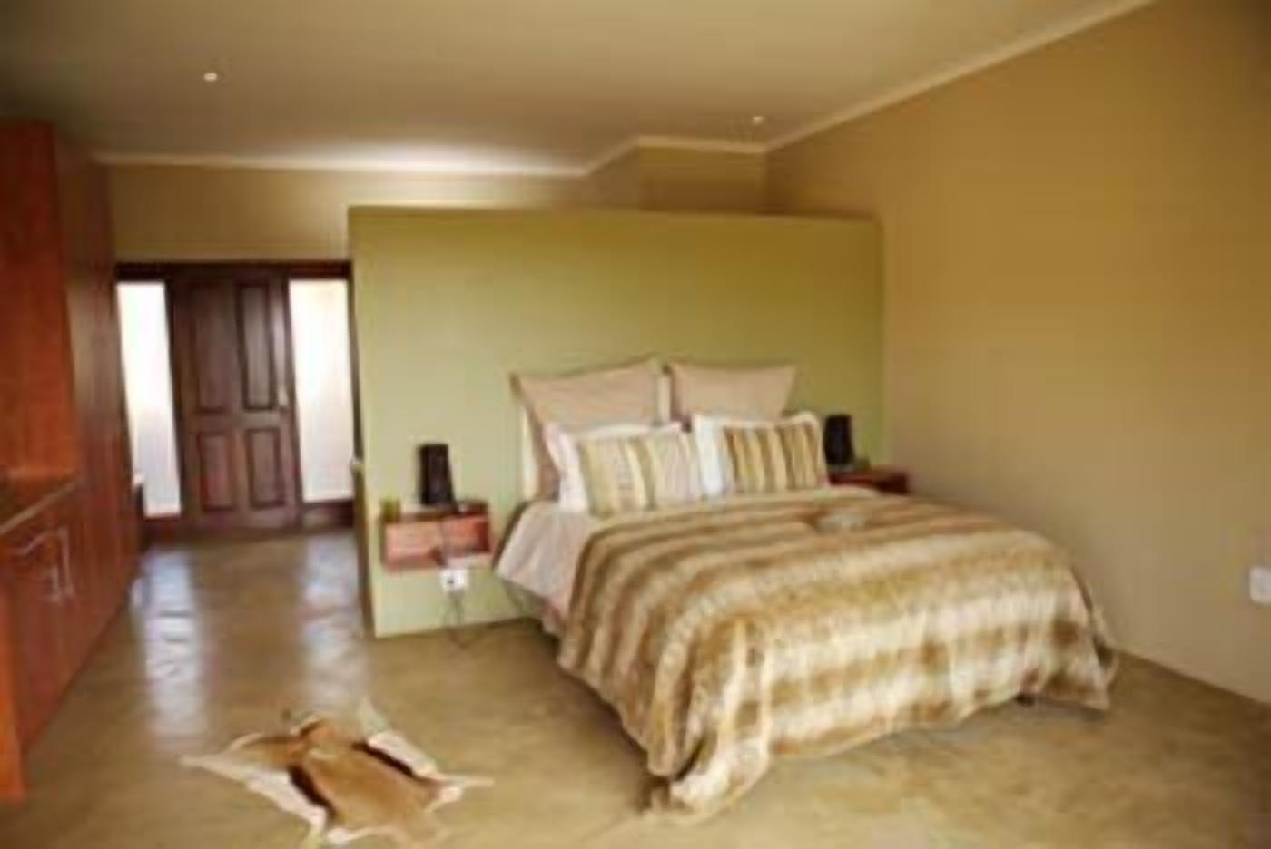 A bedroom with a bed, nightstands, and a wooden wardrobe.