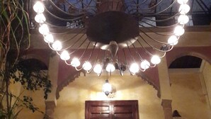A traditional building with a large, ornate chandelier and a central wooden door. - Riad Marlinea (Salé)