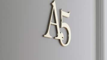 A metallic number 'A5' on a wall, indicating room number.