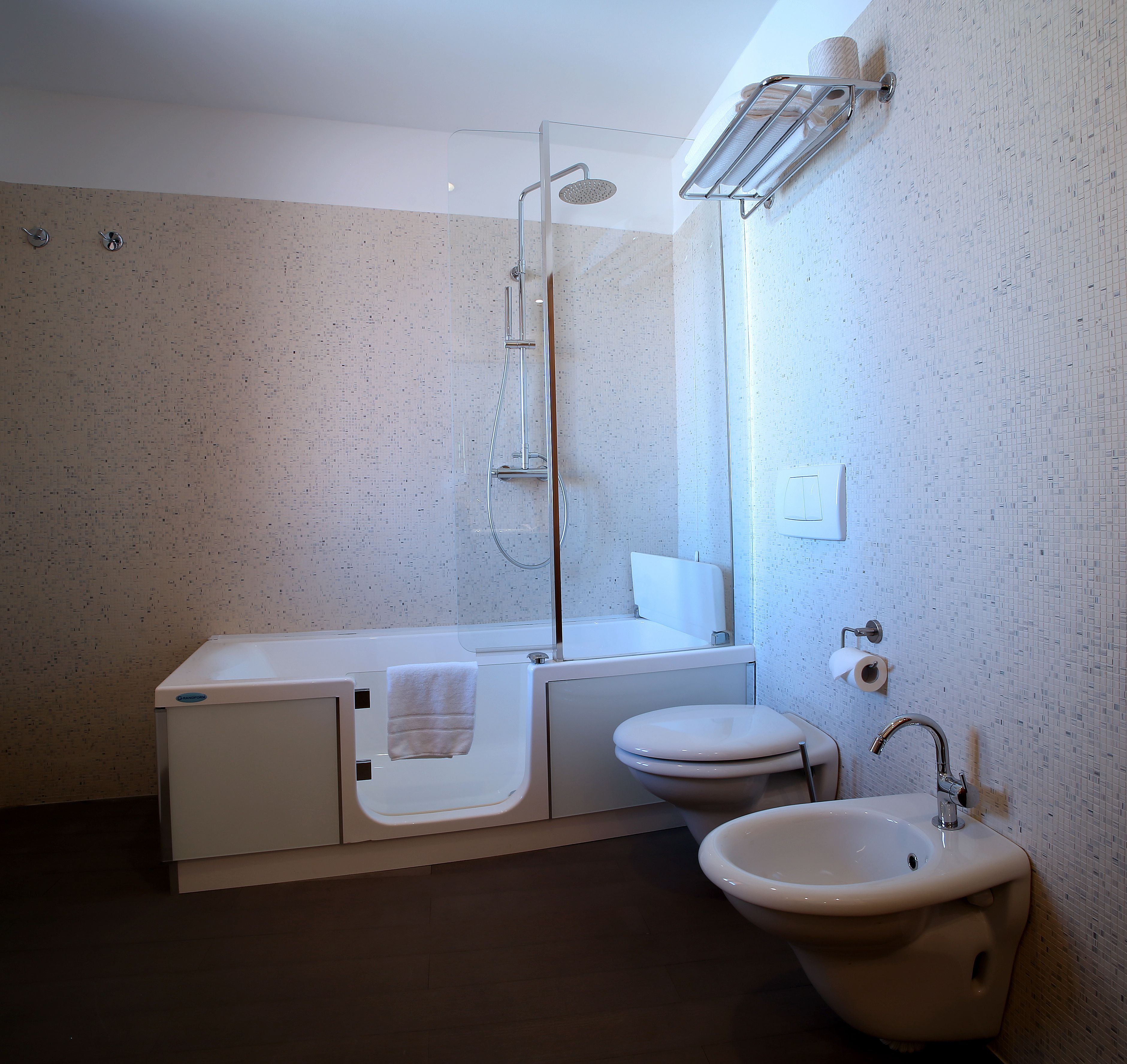 A modern bathroom with a shower, toilet, and sink.