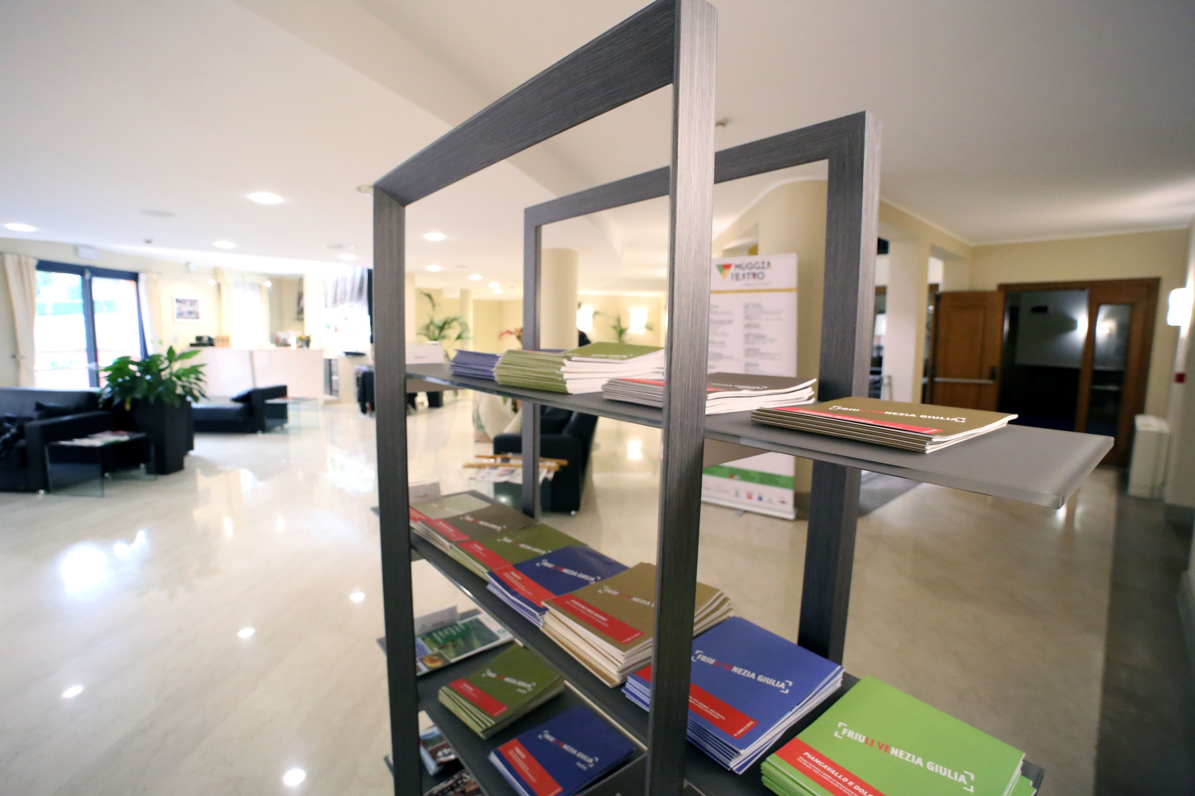 A library with bookshelves and a reception area.