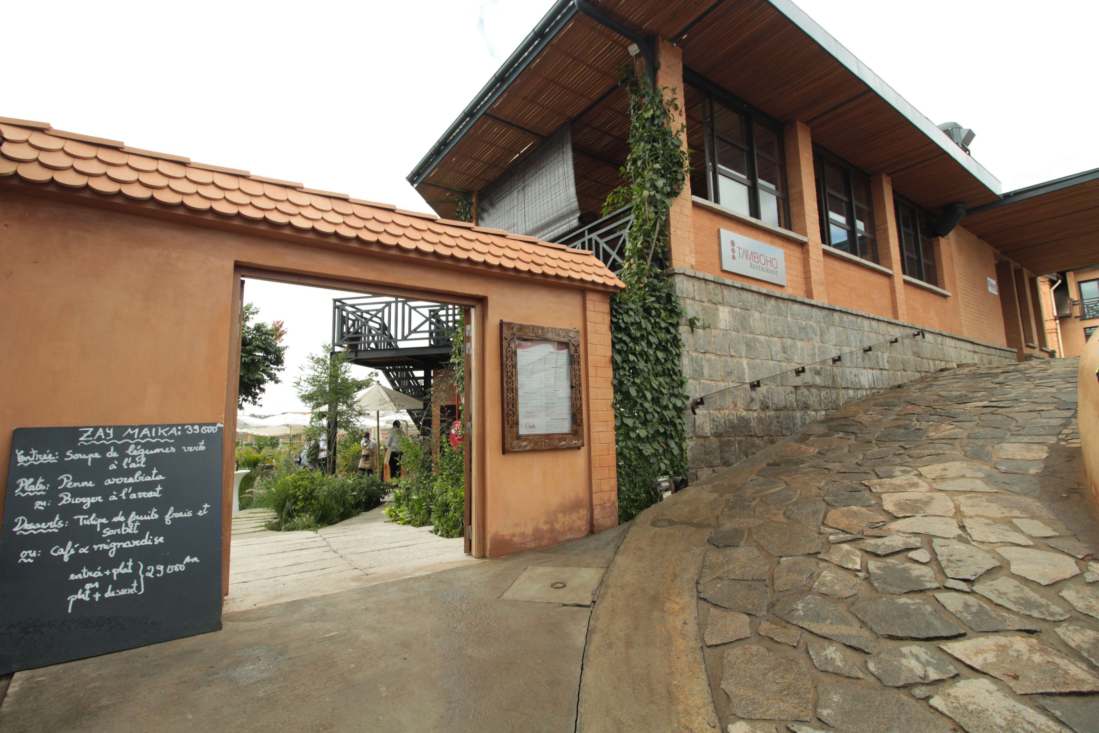 A building with a stone staircase leading to a wooden door.