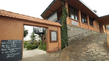 A building with a stone staircase leading to a wooden door.