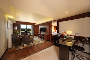 A modern hotel room with a living area, a dining space, and a kitchen. - Gokulam Grand Hotel & Spa Bangalore (Bengaluru)