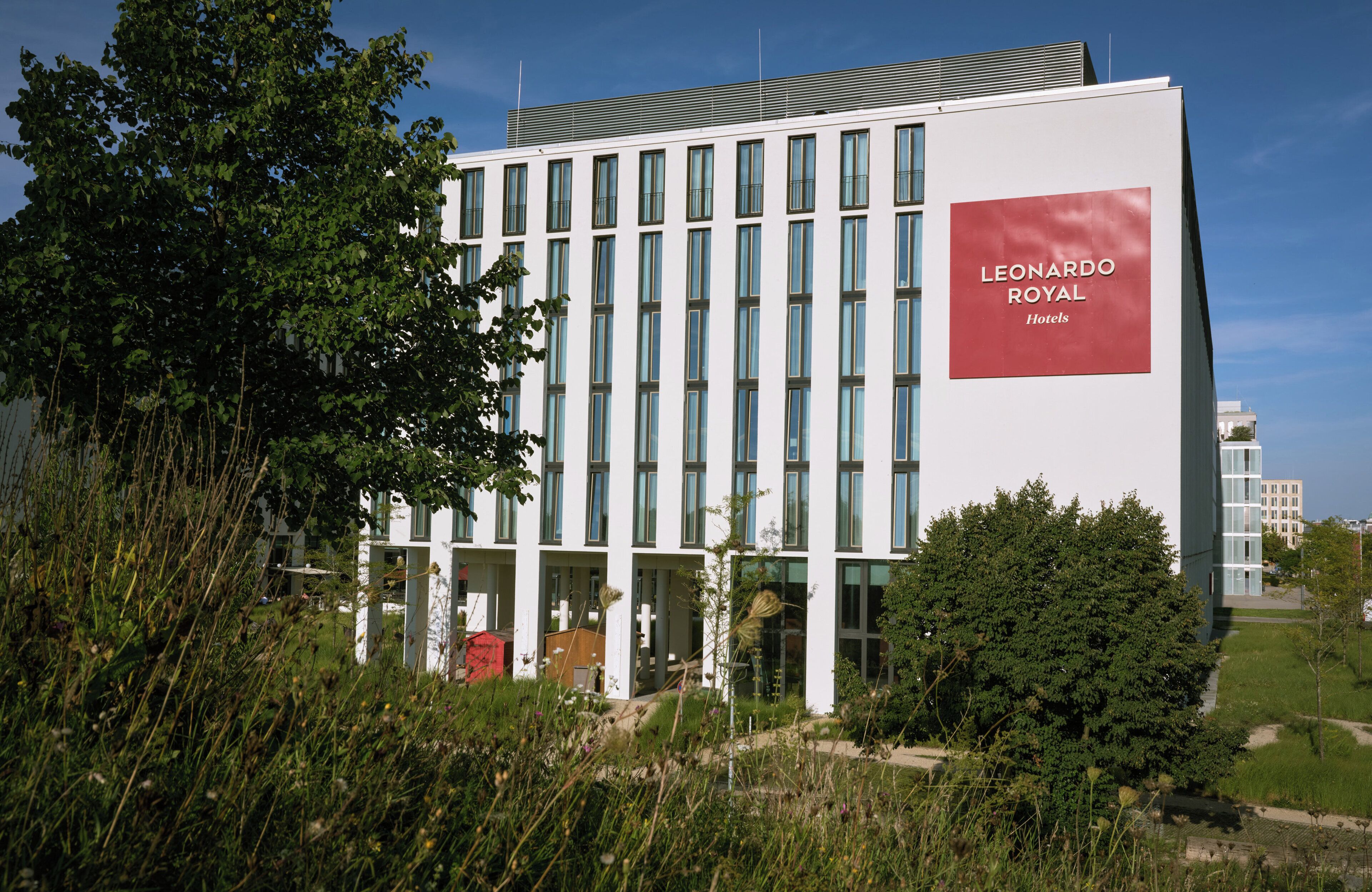 A modern building with a prominent sign for 'Leonardo Royal Hotels'.