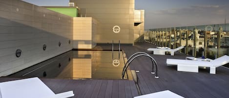 Seasonal outdoor pool, open 10:00 AM to 9:00 PM, pool umbrellas