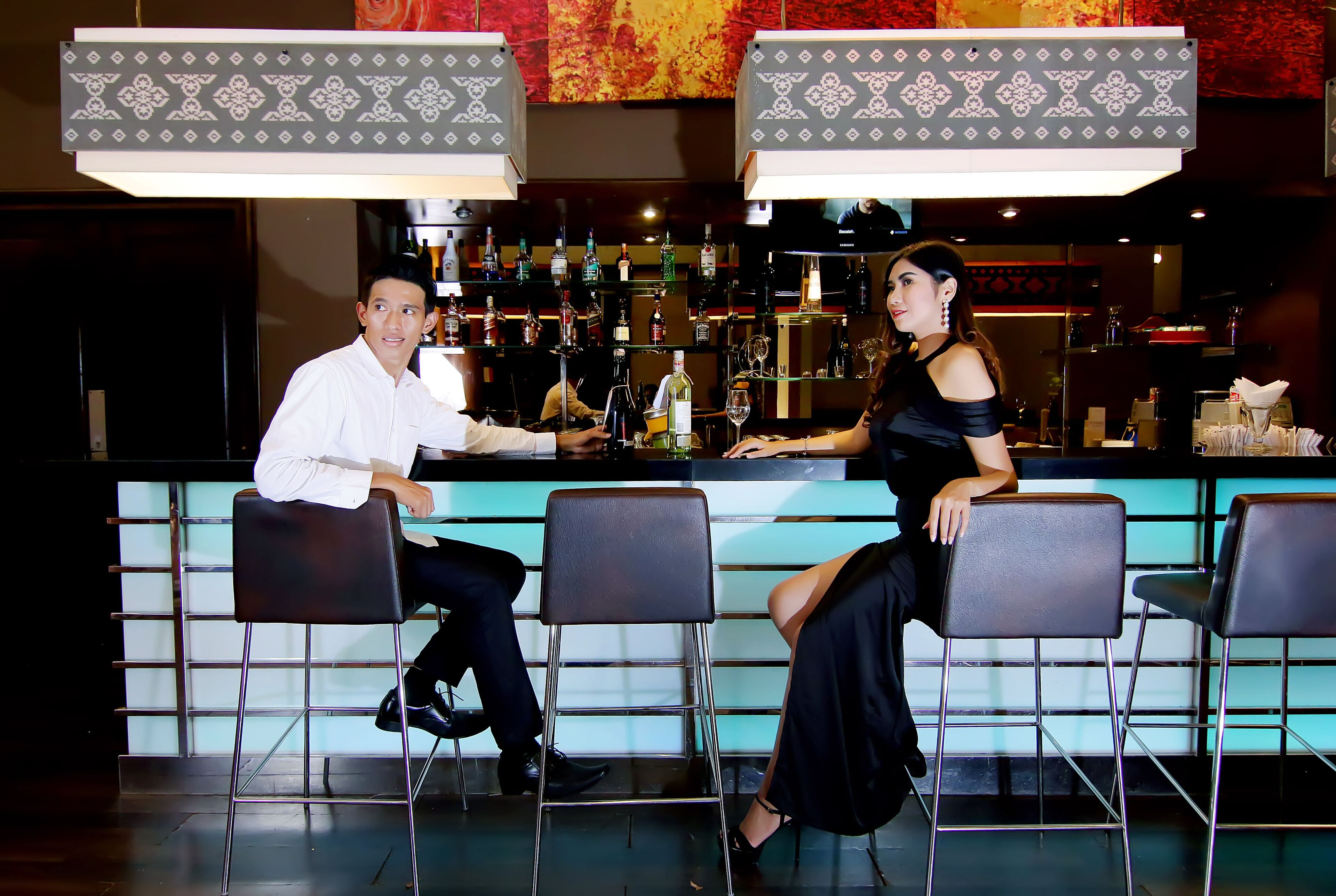 A bar area with a counter and stools.