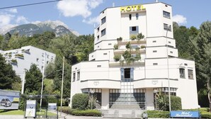 A hotel with a modern design, featuring a prominent 'HOTEL' sign at the top. - Hotel Karwendel (Innsbruck)