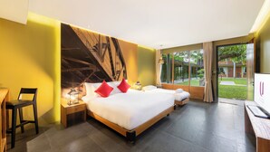 A modern hotel room with a large bed, a desk, and a view of the outdoors. - U Inchantree Kanchanaburi (Kanchanaburi)