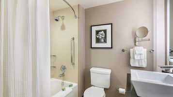 A modern bathroom with a bathtub, toilet, and sink.