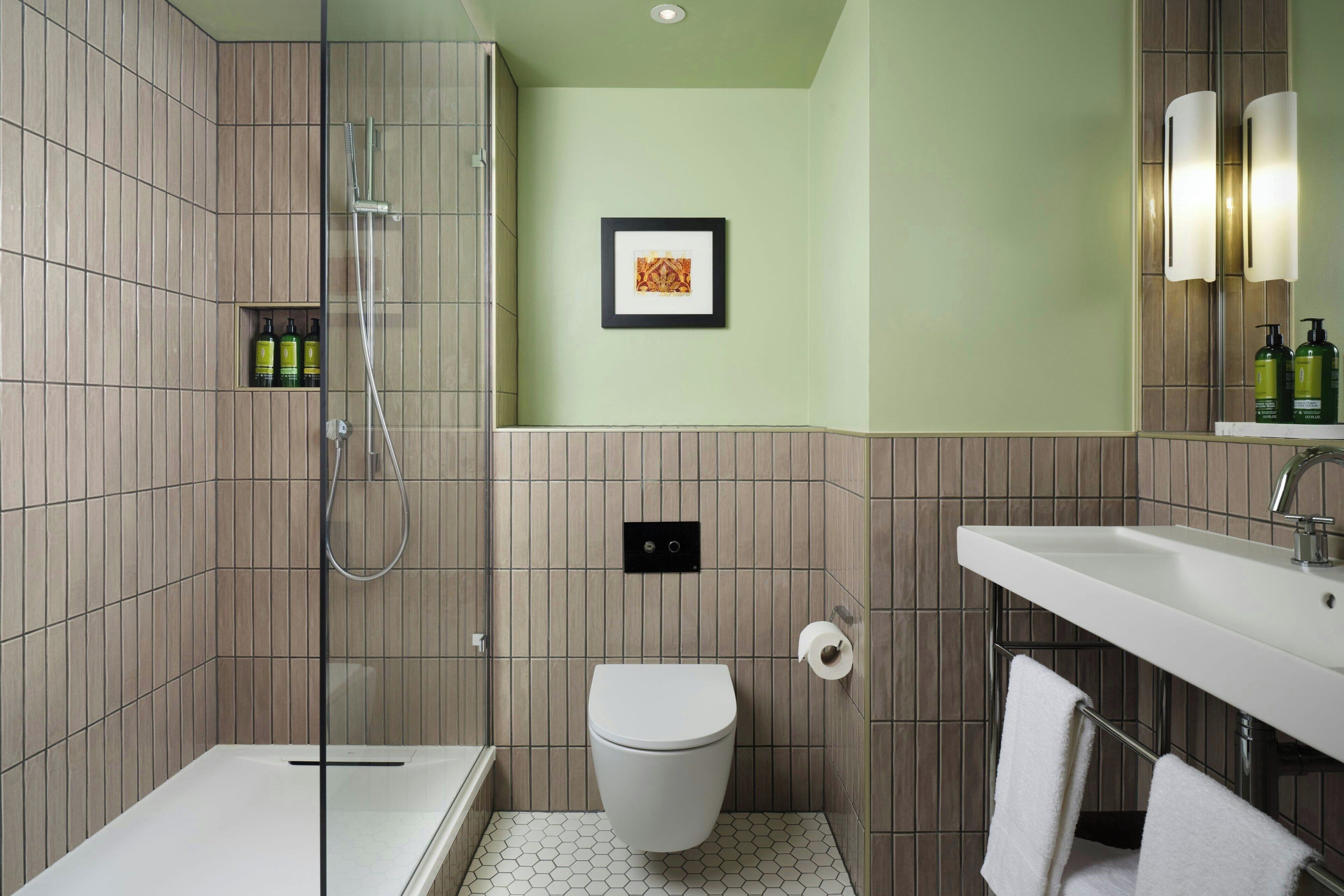 Un baño moderno con ducha, inodoro y lavamanos.