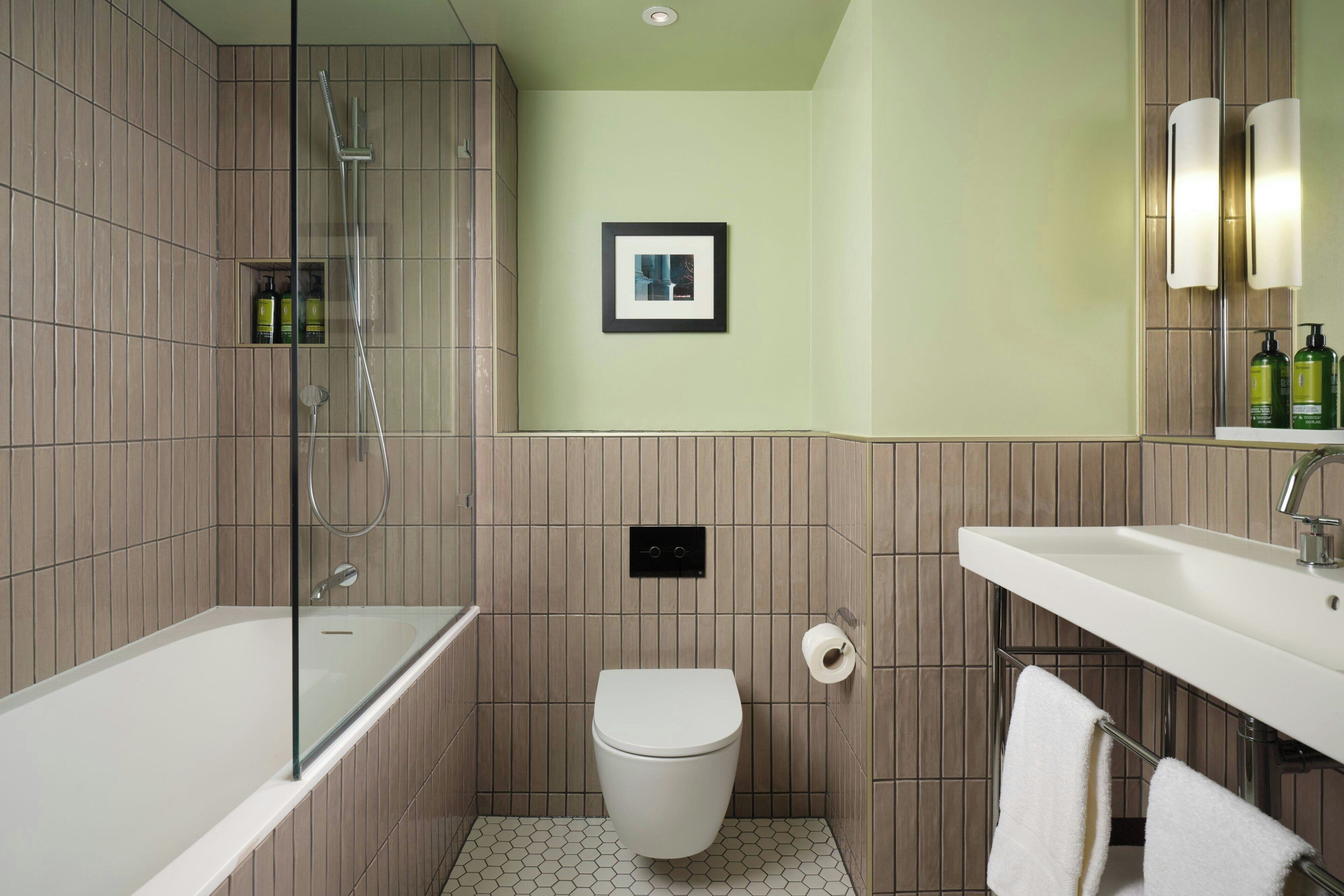 A bathroom with a bathtub, toilet, and sink.