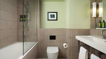 A bathroom with a bathtub, toilet, and sink.