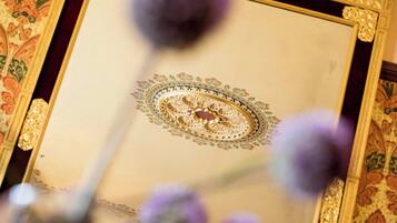 A framed artwork with intricate designs and a central circular motif.