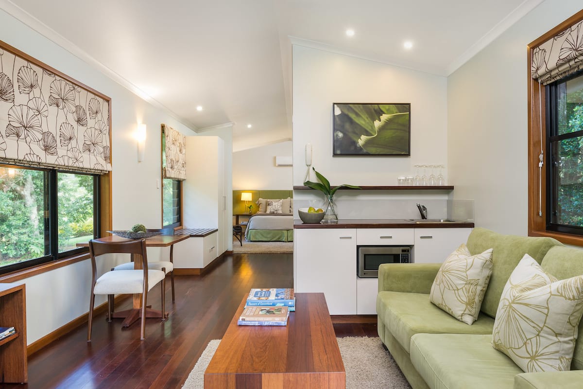 deluxe room, 1 king bed | living area | led tv, dvd player, ipod dock, pay films