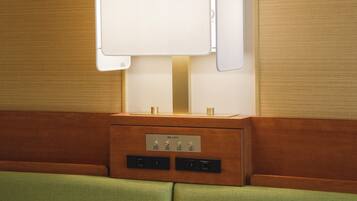 A wall-mounted light fixture with a control panel below it.